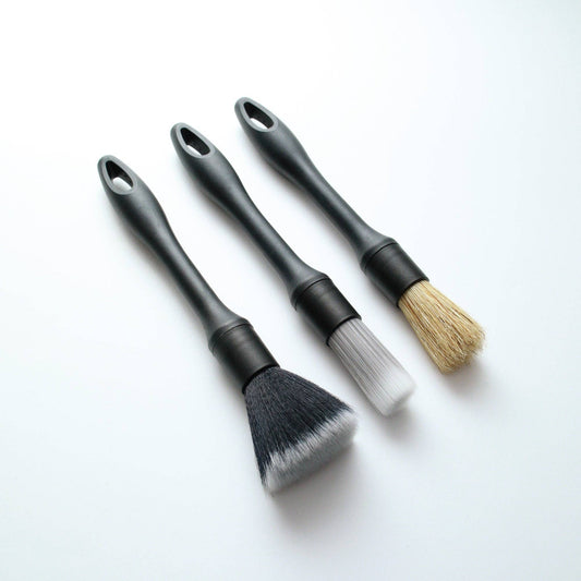3 car detailing brushes on a white background