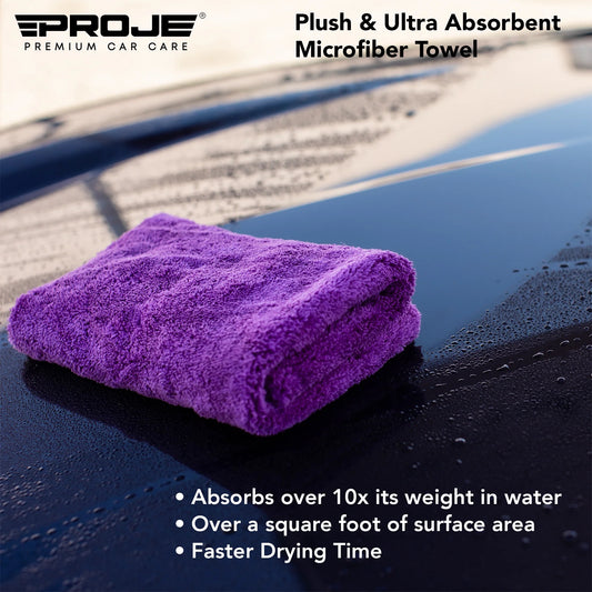 Purple microfiber towel on a car surface with PROJE logo and product features.