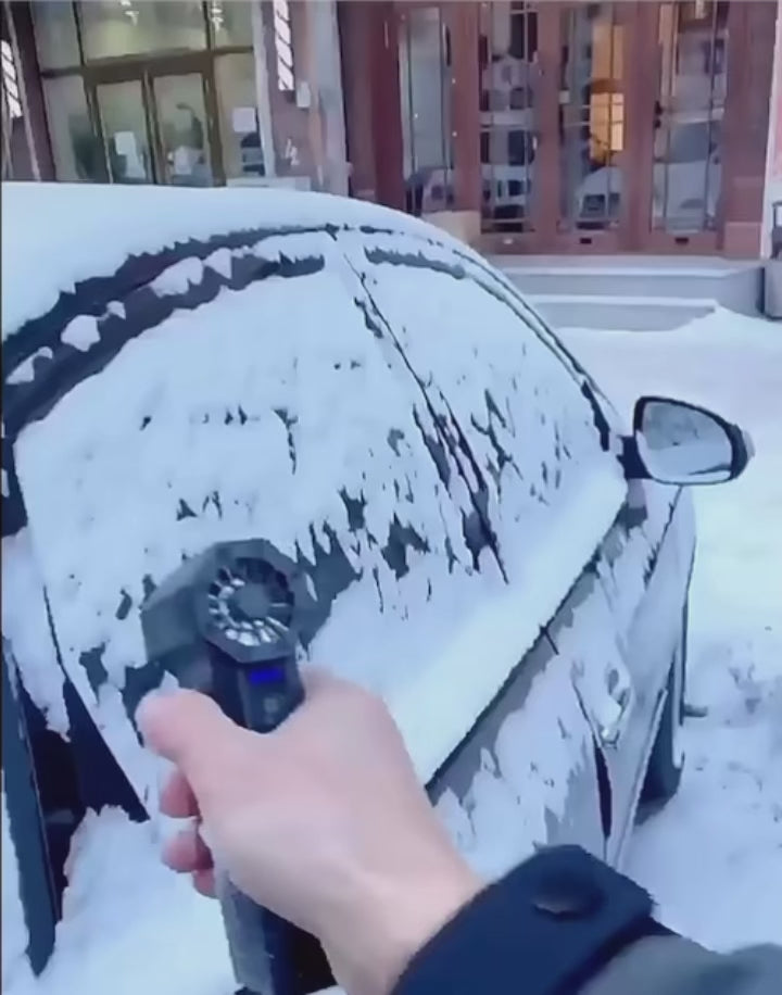 blowing snow off car with air duster