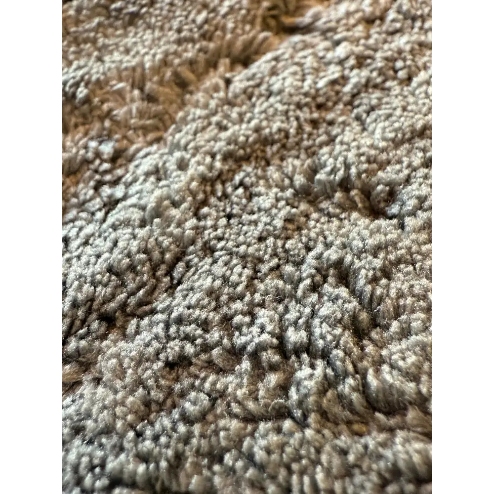 A plush, textured gray carpet with a dense, fluffy pile.