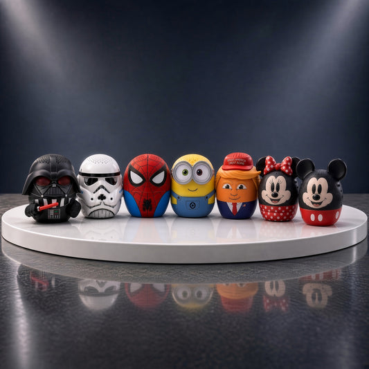Seven Bitty Boomers mini Bluetooth speakers lined up on a round stage: Darth Vader, Stormtrooper, Spider-Man, Bob the Minion, Donald Trump, Minnie Mouse and Mickey Mouse