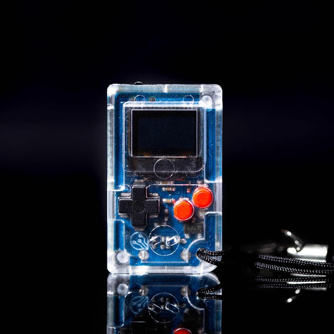 Small transparent game console with buttons on a black background