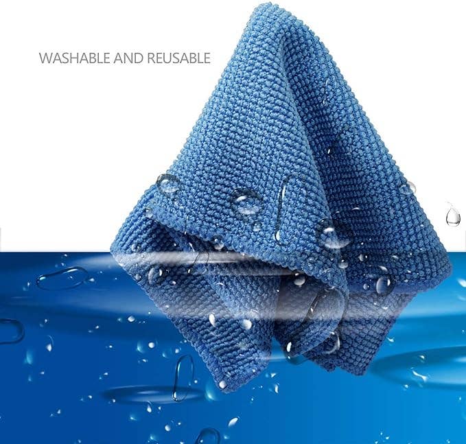 a blue microfiber cloth submerged in water 