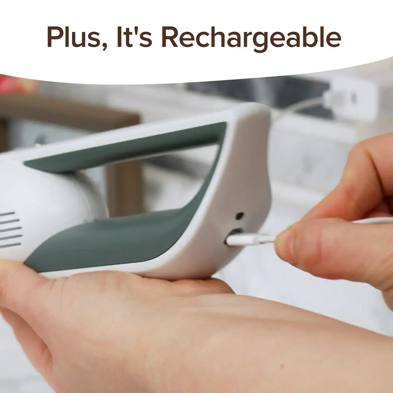 Person plugging a charging cable into a white electronic device with text 'Plus, It's Rechargeable' above.