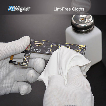 A close-up of gloved hands wiping a small electronic circuit board with a white lint-free cloth, with a white bottle in the background and the text 'AAWipes Lint-Free Cloths' at the top.