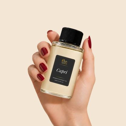 Hand holding a bottle of Hello Aromas Capri fragrance oil.