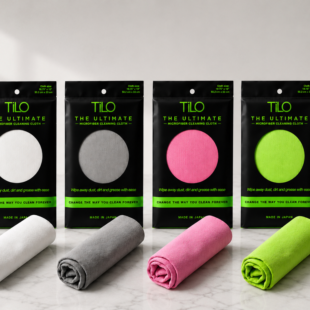 Five folded towels in white, gray, pink, and green with their packaging on a light background.