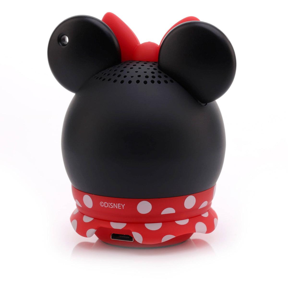 A black spherical speaker designed like Minnie Mouse's head, featuring red ears, a red bow, and a red polka-dot skirt, with the Disney logo printed on the skirt.