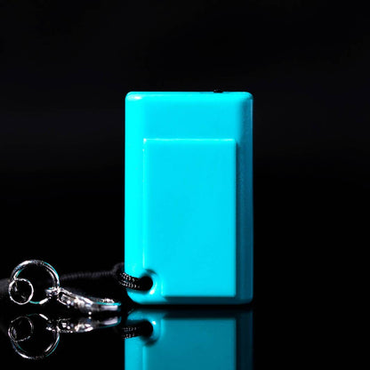 The back of the teal tiny game console on a black background with a keychain attached. 
