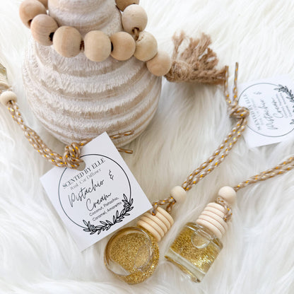 small bottles and wooden beads on a soft white surface