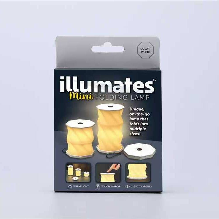 Packaged Illumates Mini Folding Lamp in white, shown in its retail box against a light gray background.