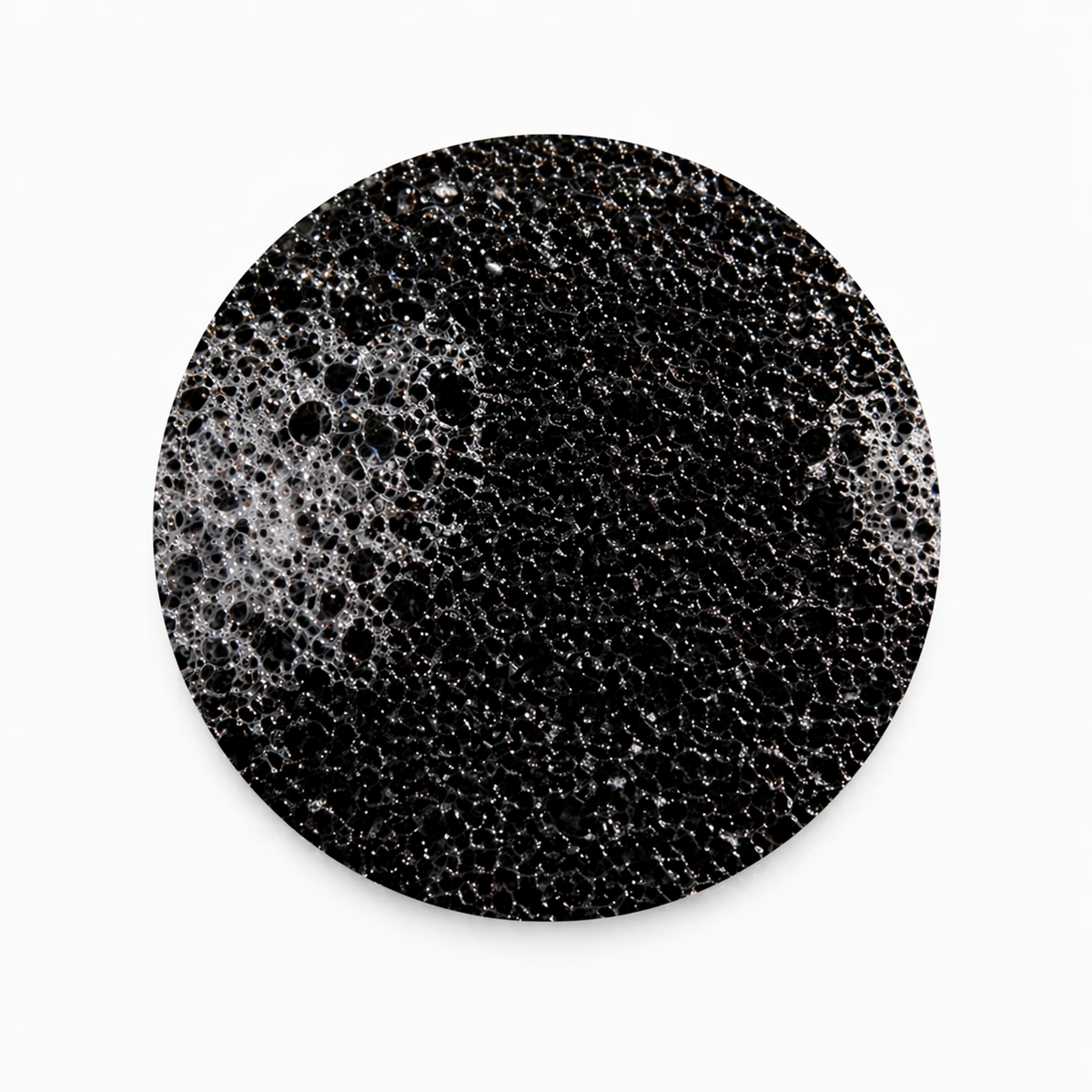 close up of the black ORB sponge on a white background