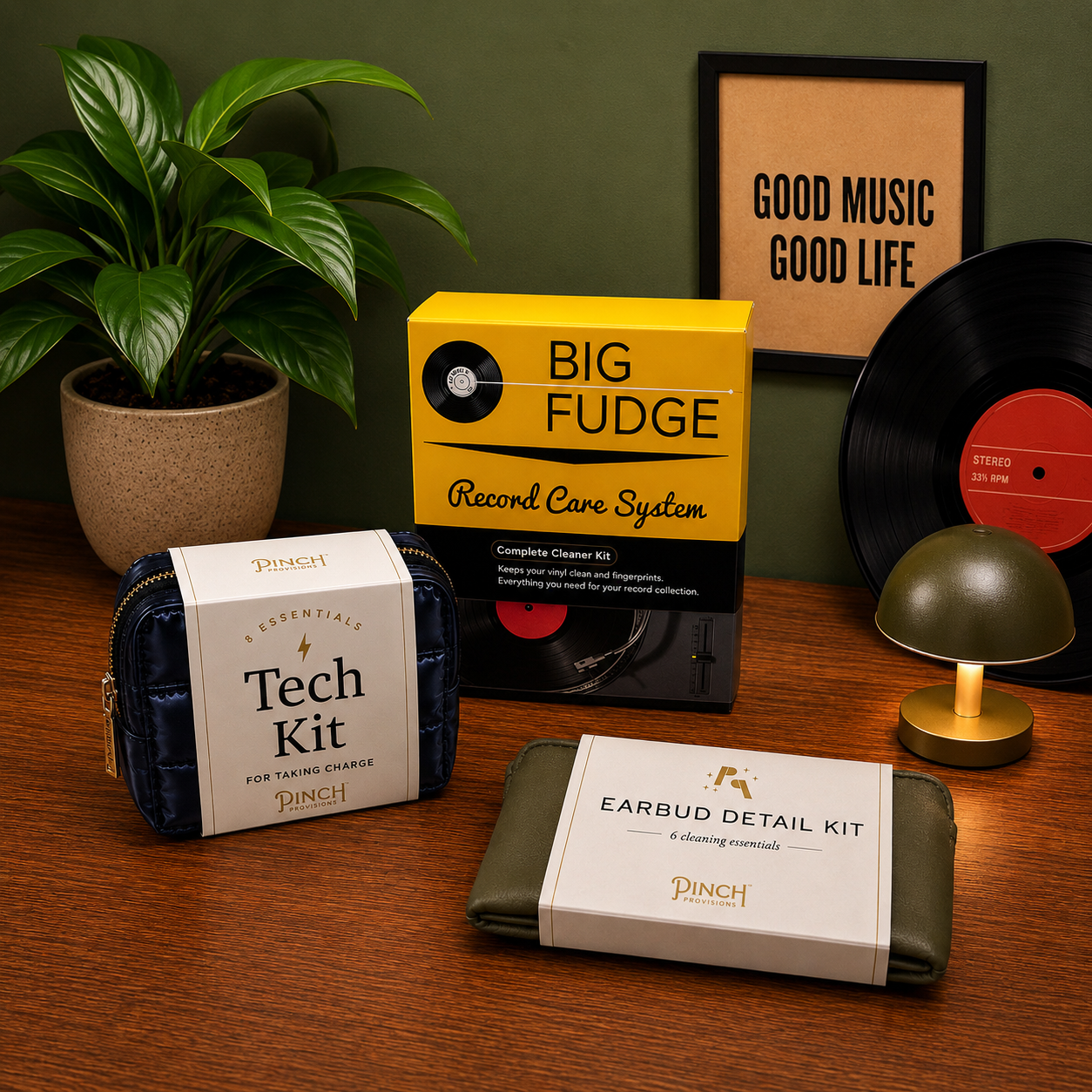 Collection of tech and record care kits on a wooden surface with decorative items.