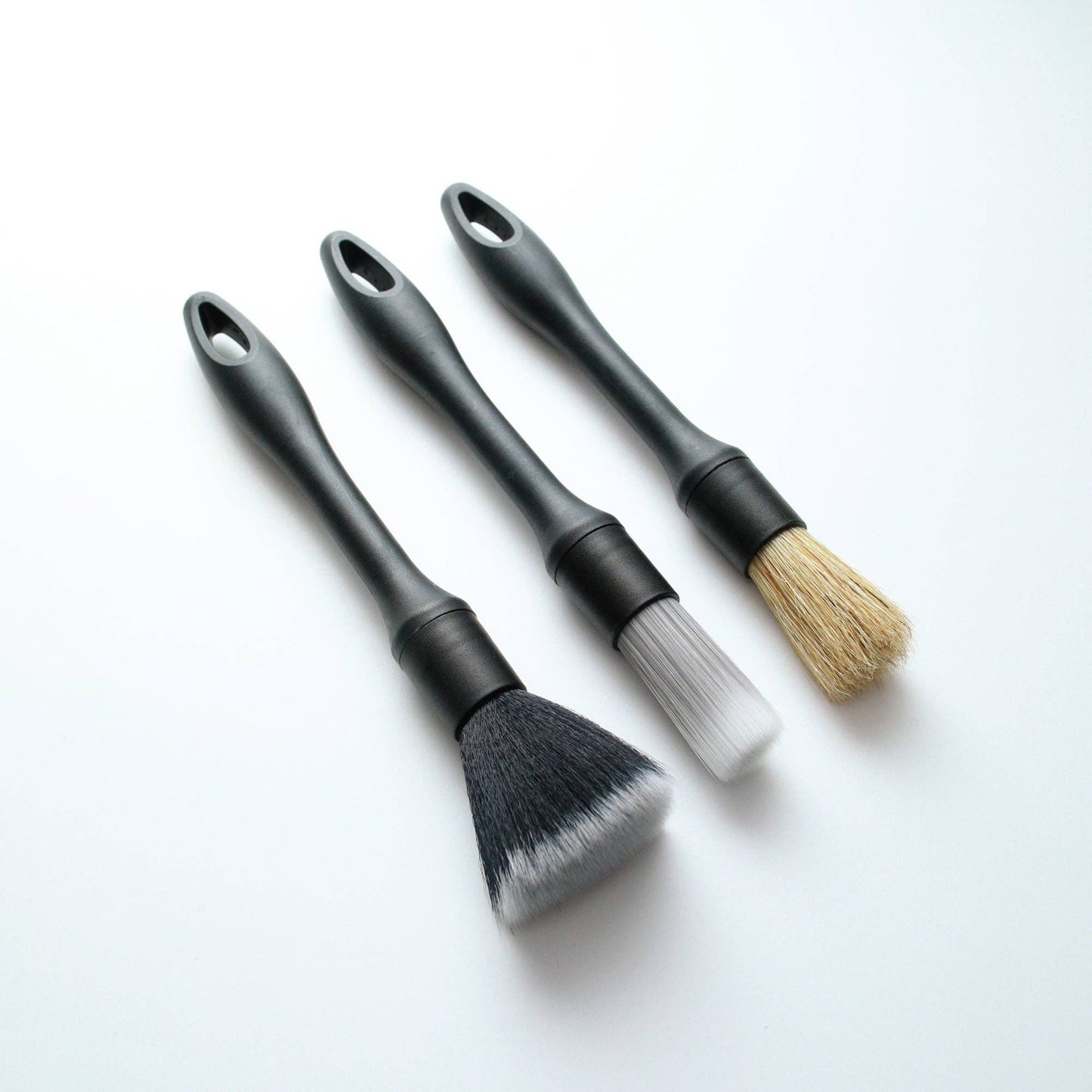 3 car detailing brushes on a white background