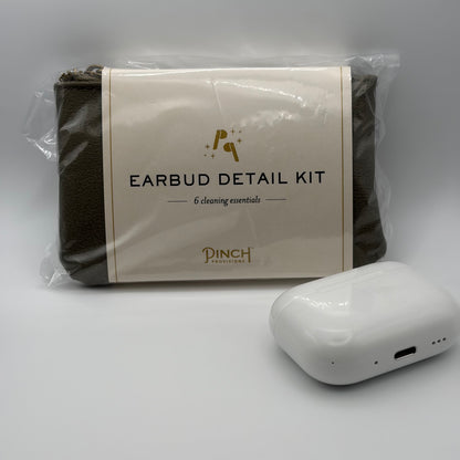 Earbud detail kit with cleaning essentials and a white earbud device on a gray background