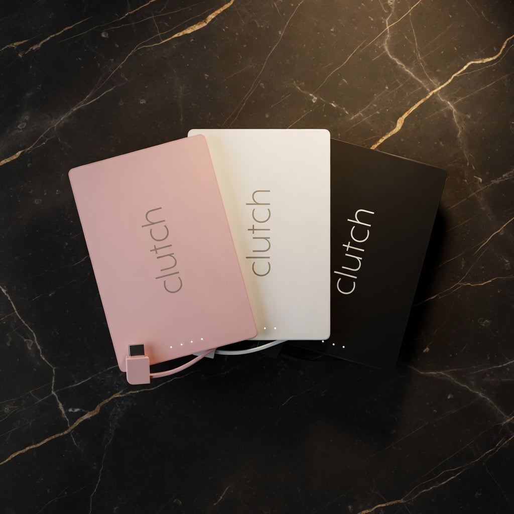Three 'clutch' products on a dark marble surface