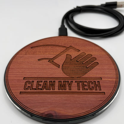 Wooden round charger with 'Clean My Tech' engraving and USB cable on a white background