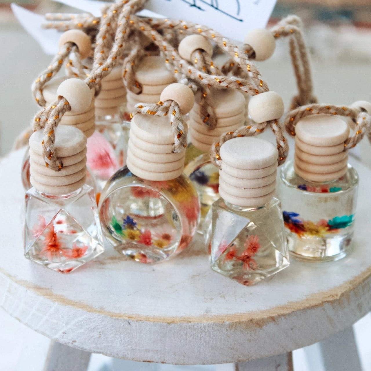 Set of small glass bottles with colorful contents on a white surface