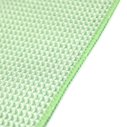Close-up of a textured green fabric on a white background