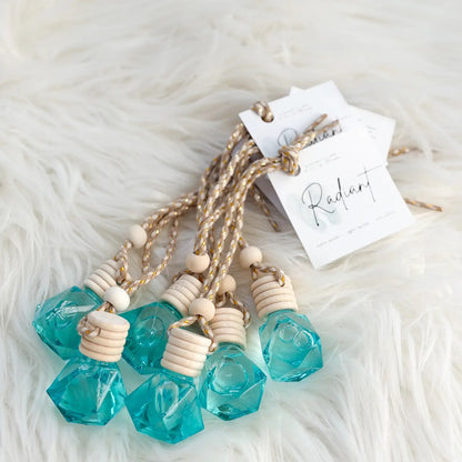 small bottles containing blue liquid with tags labeled Radiant