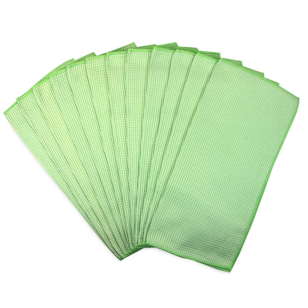 Set of green microfiber cloths on a white background