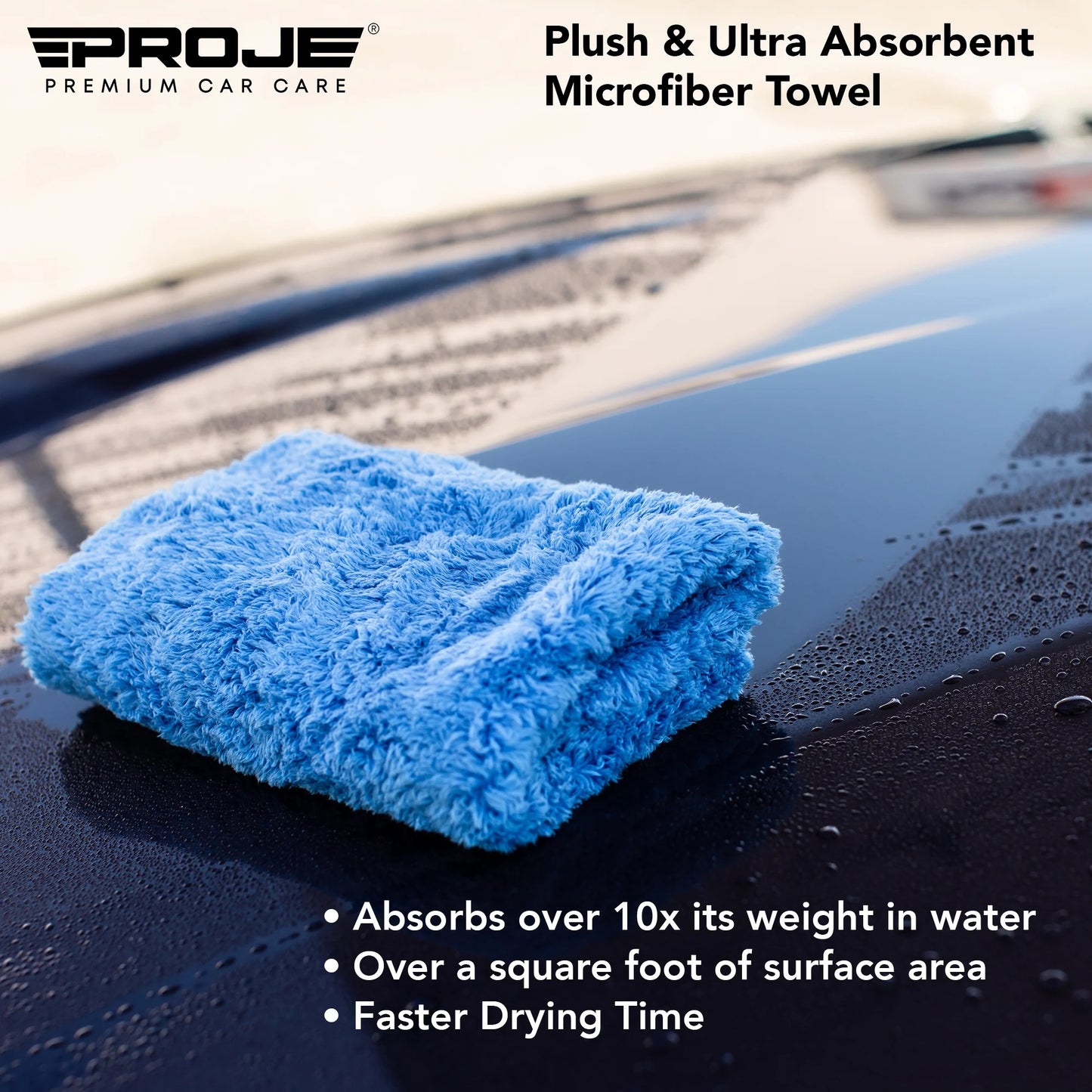 A folded light blue plush microfiber car towel resting on a wet black car hood, with the Proje Premium Car Care logo and product text overlaid on the image.