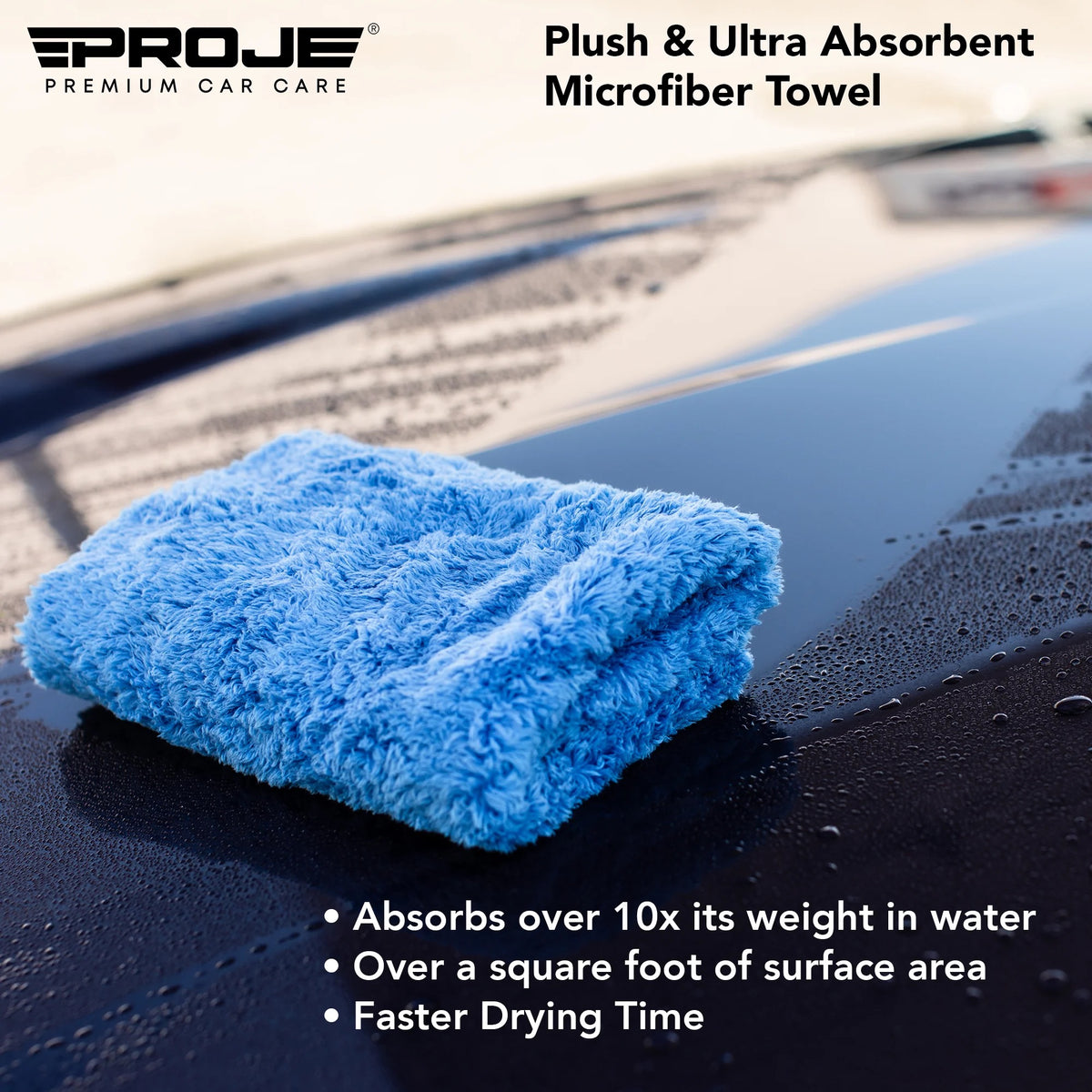 A folded light blue plush microfiber car towel resting on a wet black car hood, with the Proje Premium Car Care logo and product text overlaid on the image.