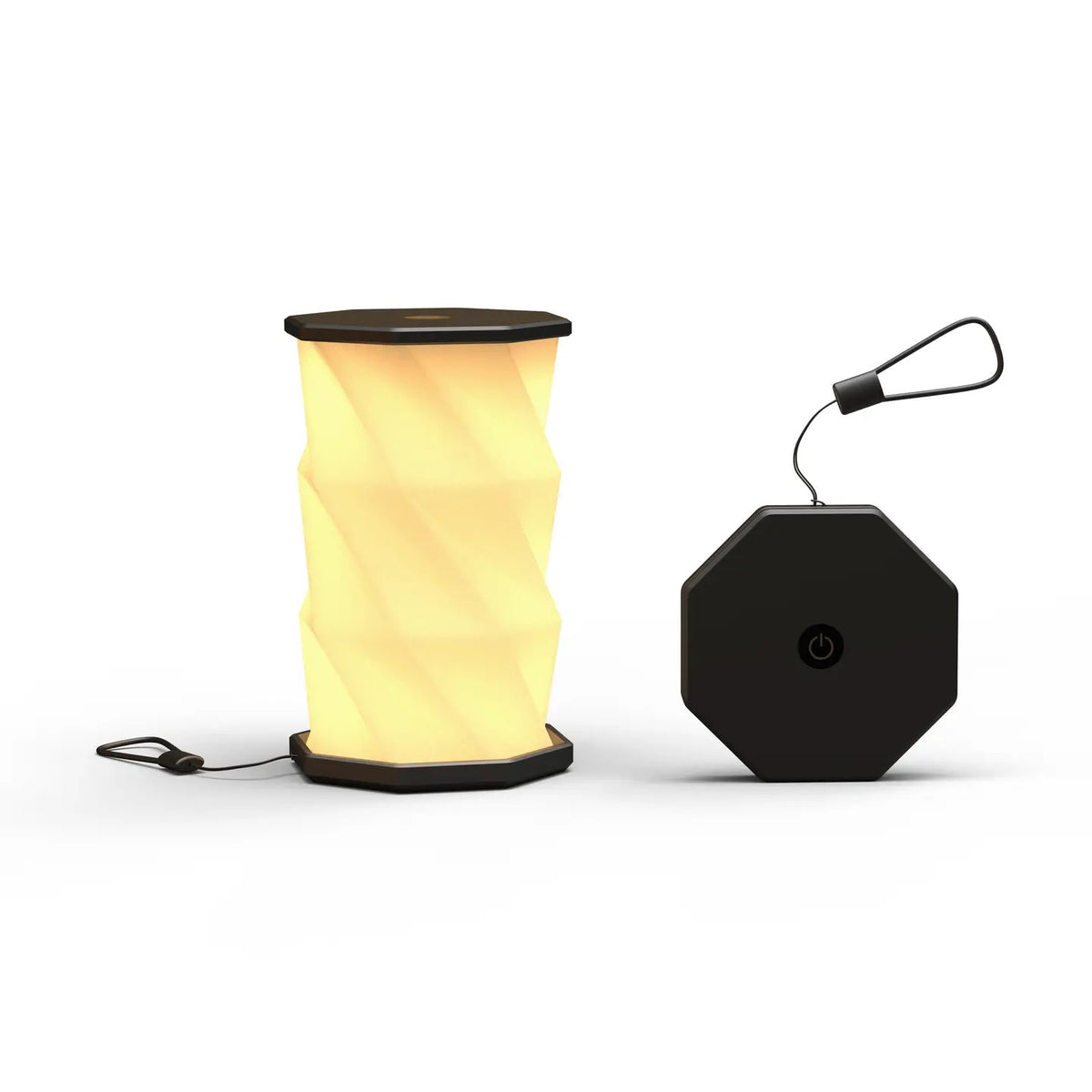 A black portable folding lamp  shown on a clean white background. The lamp is unfolded and illuminated with a geometric, faceted design in warm yellow.