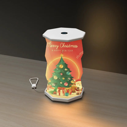 A Christmas portable folding lamp  shown on a clean white background. The lamp is unfolded and illuminated with a geometric, faceted design in warm yellow.