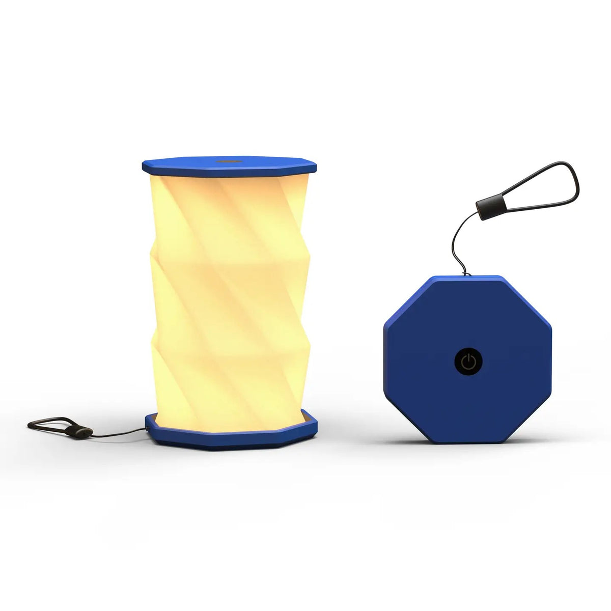 A navy portable folding lamp  shown on a clean white background. The lamp is unfolded and illuminated with a geometric, faceted design in warm yellow.