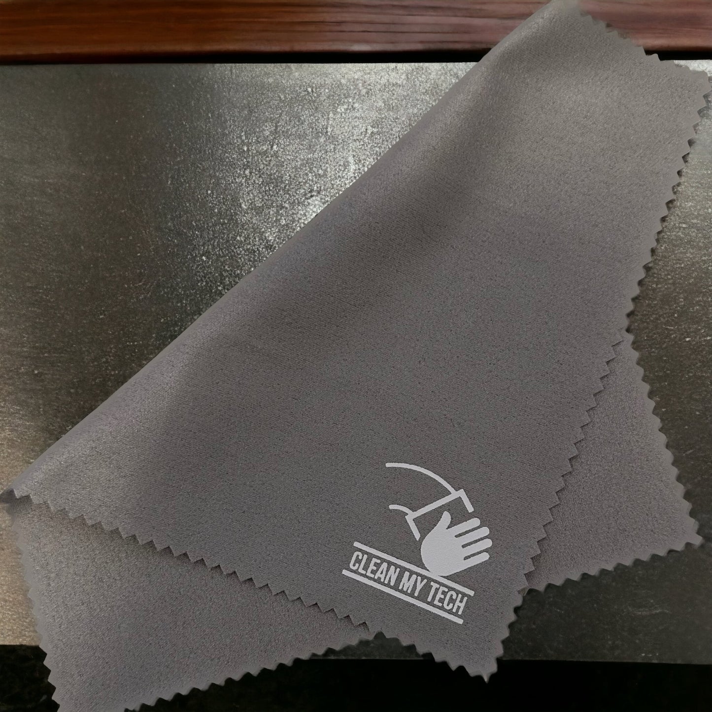 Folded over grey Clean My Tech Microfiber cloth.
