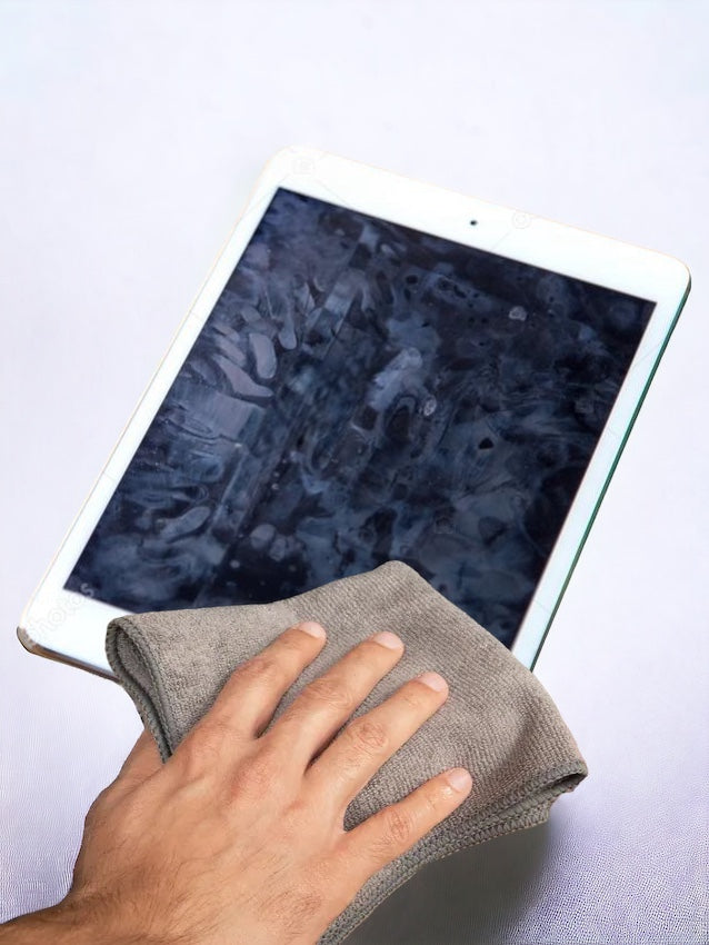 Cleaning a iPad with a grey antimicrobial microfiber cloth