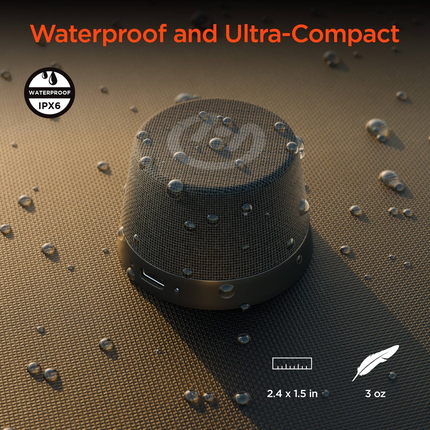 Black portable speaker on a textured surface with water droplets, highlighting waterproof feature.