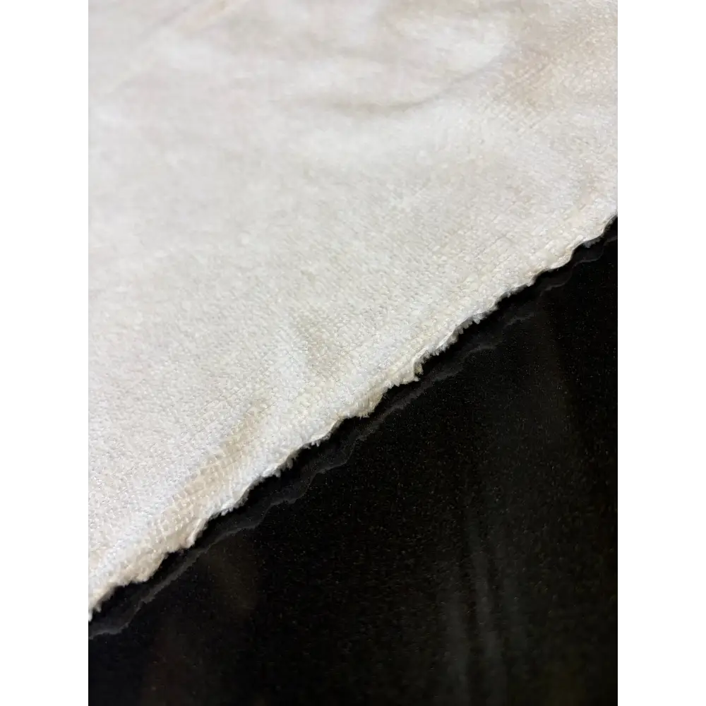 A soft, off-white cotton fabric with a slightly textured weave and frayed edges.