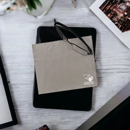 Beige microfiber cleaning cloth with a white logo and serrated edges, branded ’clean my tech.’