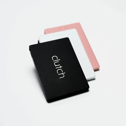 Black rectangular clutch portable power bank with white logo and rounded edges.