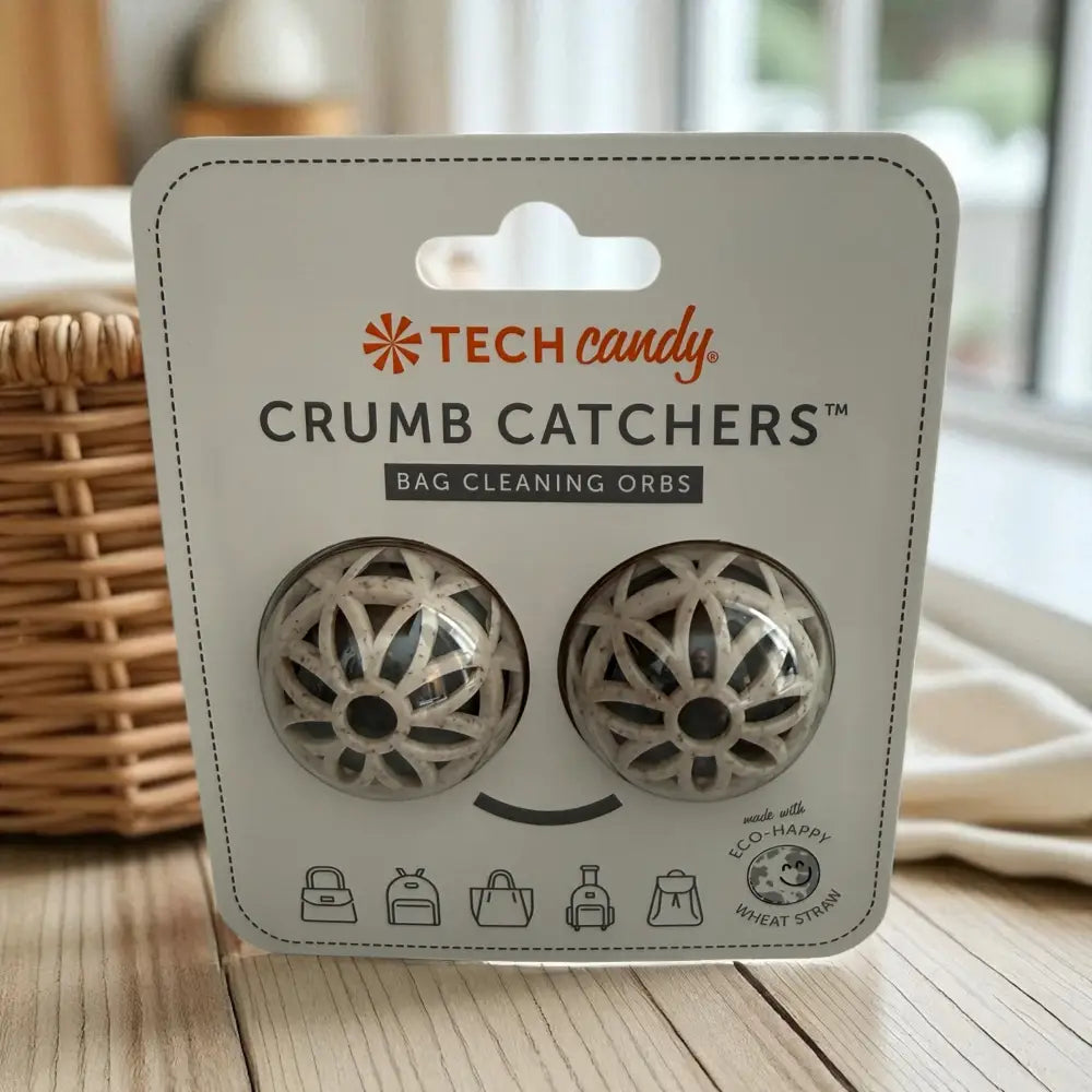 Tech candy crumb catchers, two spherical bag cleaning orbs with a white and gray woven design made from wheat straw.
