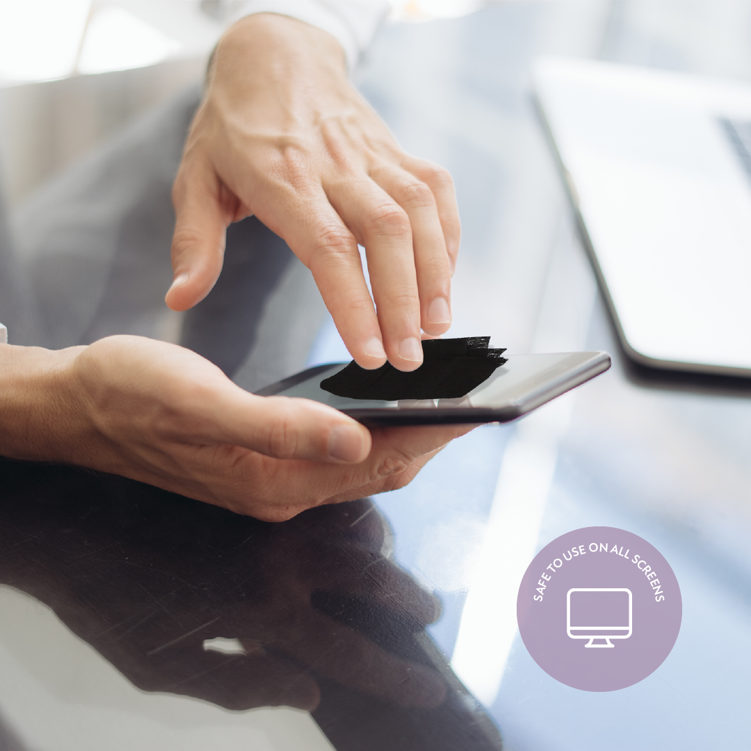 Person cleaning a smartphone with a blurred background