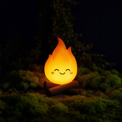 Flame-shaped night light with a smiling face on a dark background
