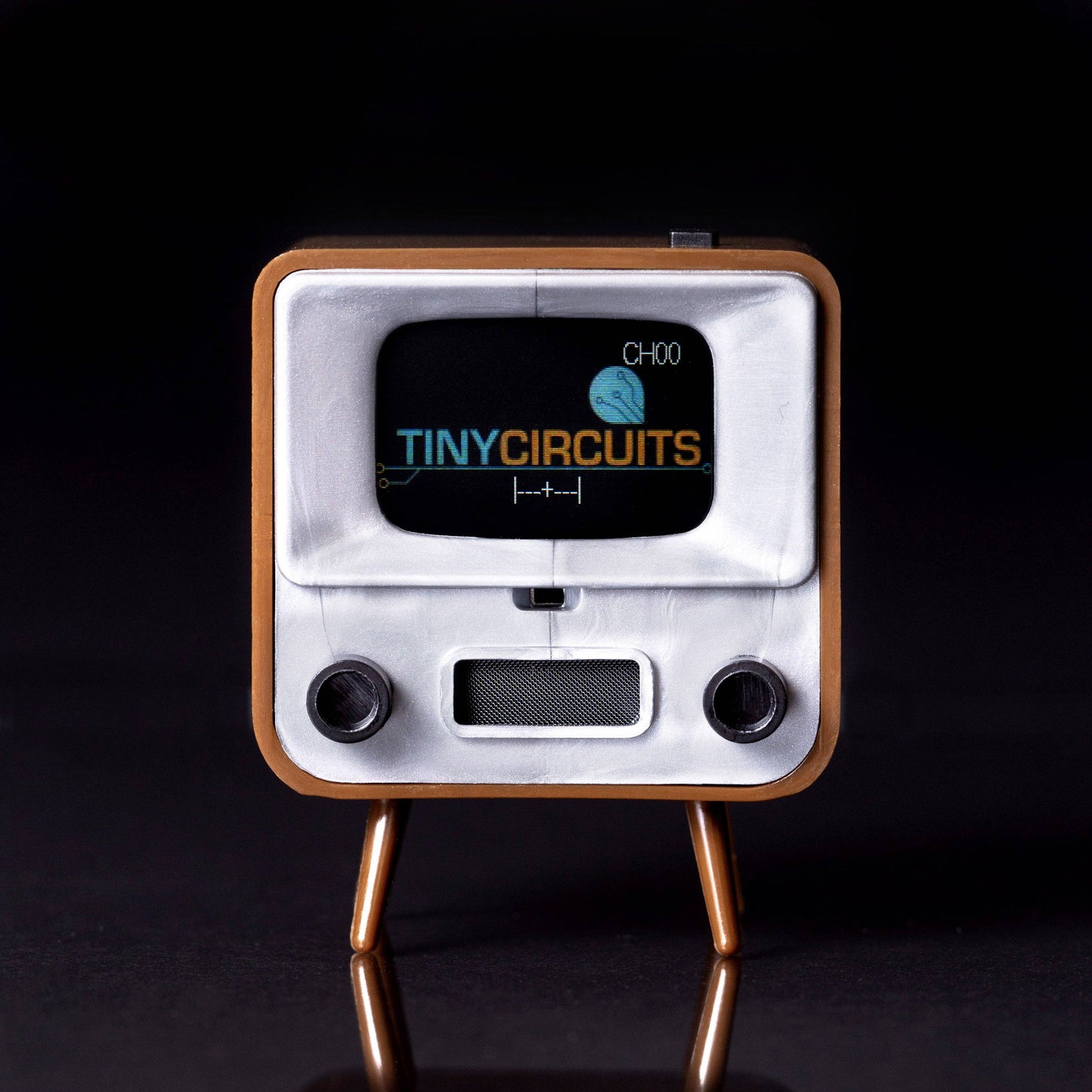 Vintage-style electronic device with 'Tiny Circuits' branding on a black background