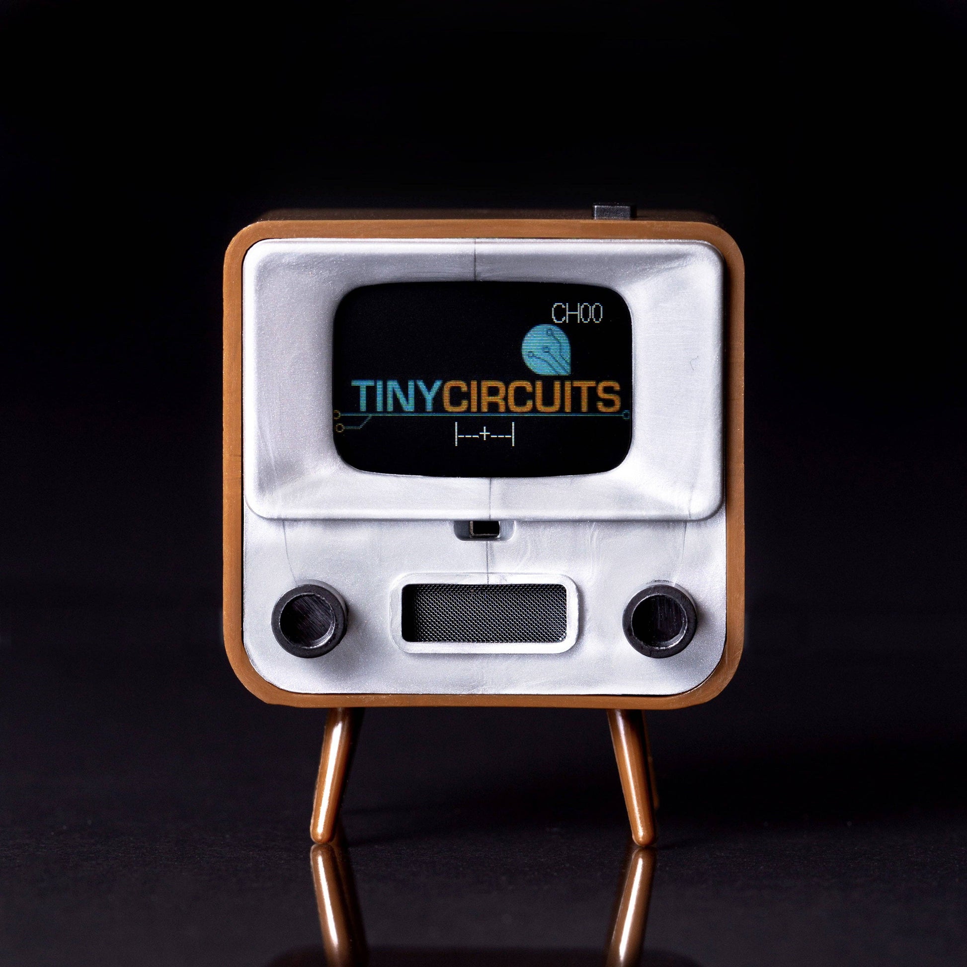 Vintage-style electronic device with 'Tiny Circuits' branding on a black background