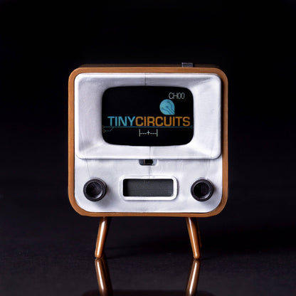 Vintage-style electronic device with 'Tiny Circuits' branding on a black background