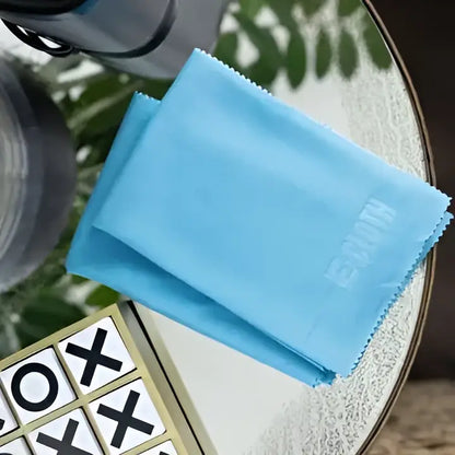 Light blue microfiber cleaning cloth with a subtle embossed logo.