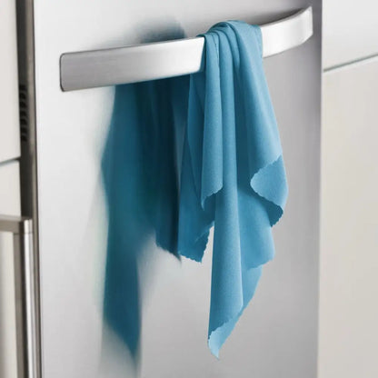A teal microfiber cleaning cloth draped over a sleek silver refrigerator handle.