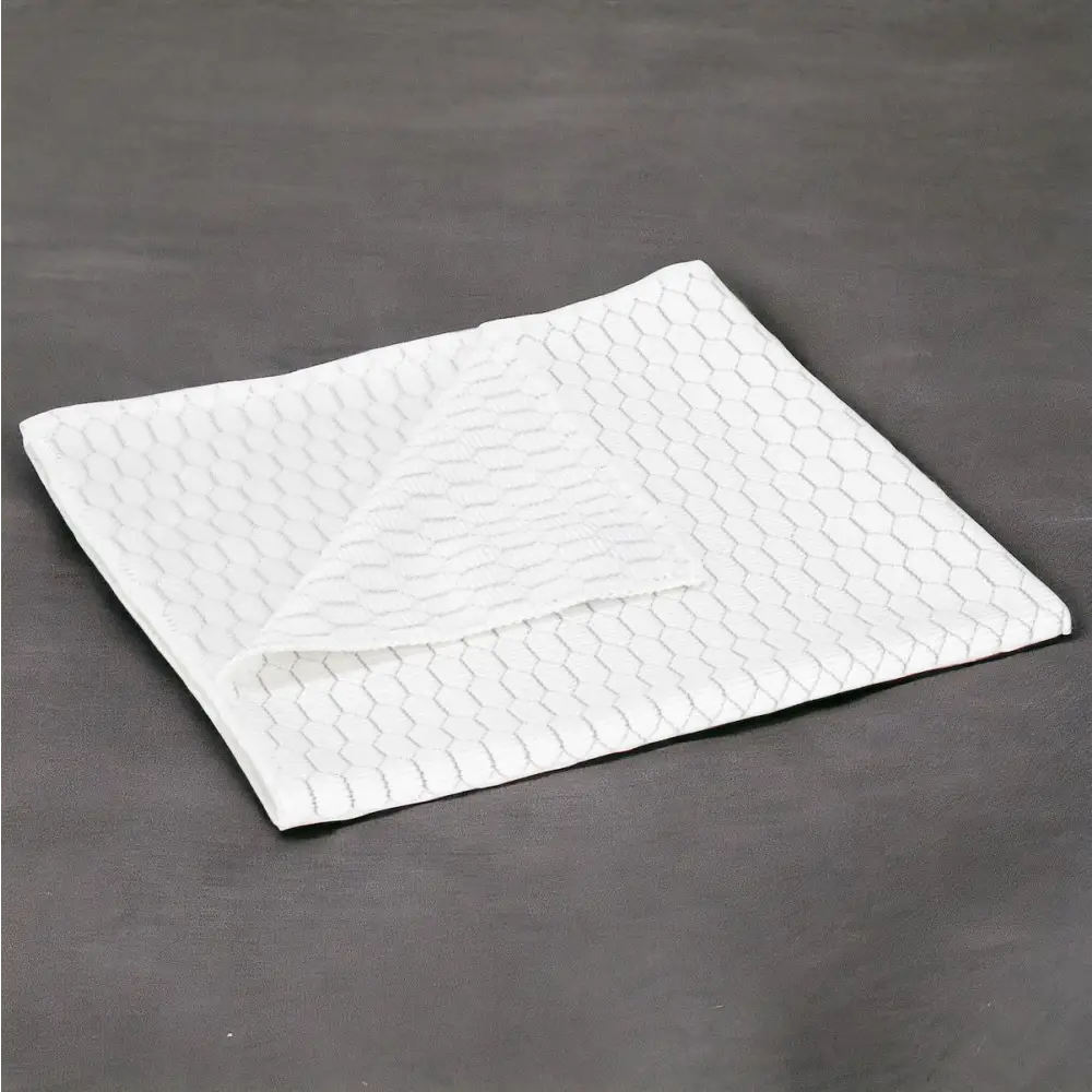 White absorbent pad with a subtle hexagonal texture pattern.