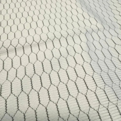 White fabric with a black hexagonal mesh pattern.