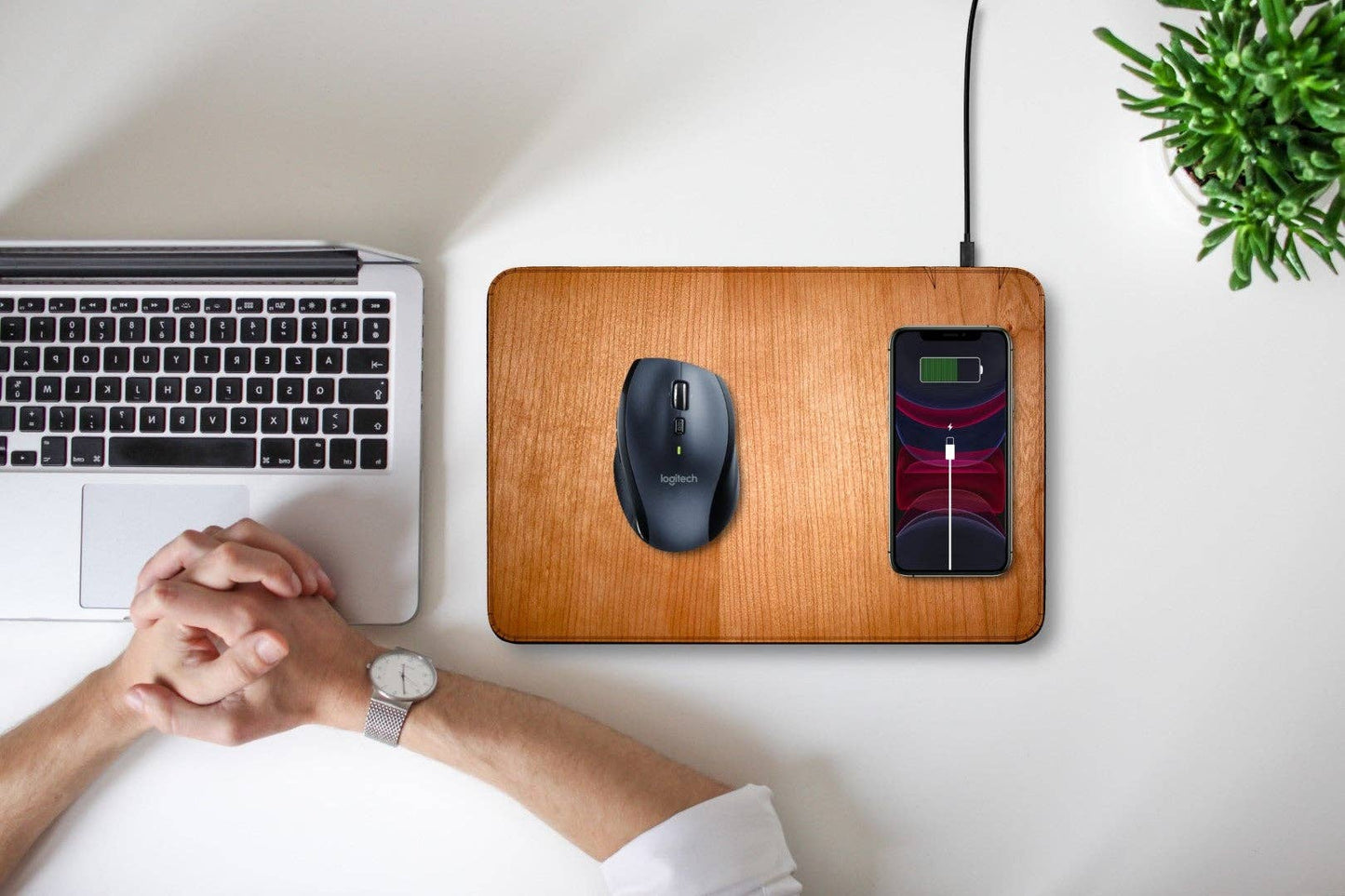 WUDN large real wood wireless charging mouse pad with built-in 15W Qi fast charger, shown with a mouse and iPhone on a white table with a man in front of his laptop computer