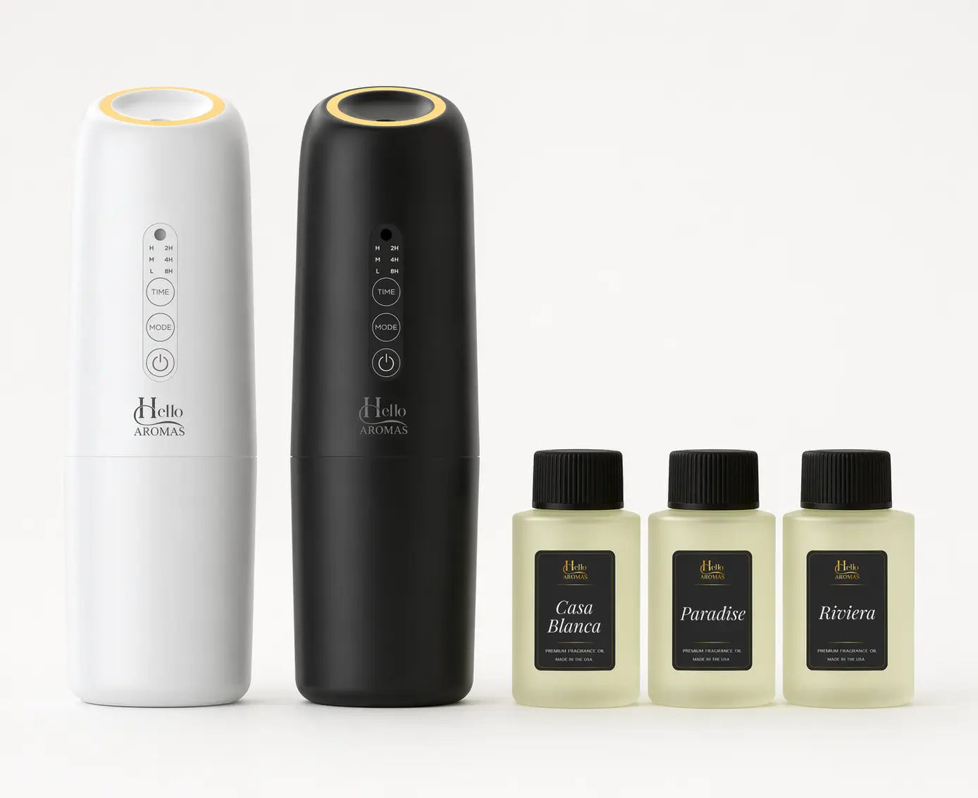 White and black hello aromas oasis plug-in scent diffusers with gold tops and three fragrance oil bottles labeled casa blanca paradise and riviera
