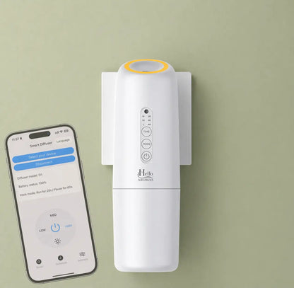 White hello aromas oasis plug-in scent diffuser with yellow rim and control buttons mounted on a wall