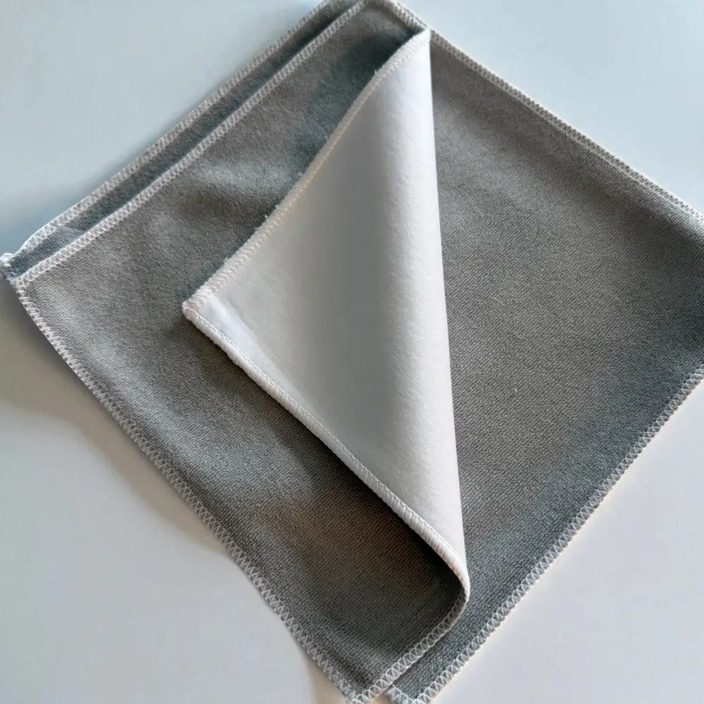 Gray microfiber cleaning cloth with a soft white interior and neatly stitched edges.